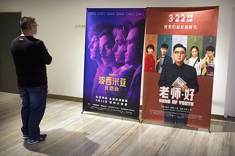 A customer looks at a movie poster for the film 'Bohemian Rhapsody' at a movie theater in Beijing, Wednesday, March 27, 2019. (Photo | AP)