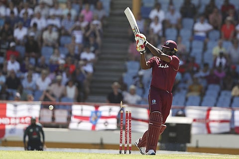 West Indies' Chris Gayle is bowled by England's Mark Wood during the fifth One Day International cricket match at the Daren Sammy Cricket Ground in Gros Islet, St. Lucia, Saturday, March 2, 2019. | AP