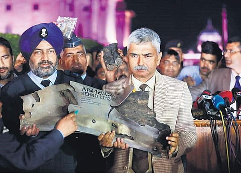 Indian Air Force officials display a piece of an AMRAAM missile, from a Pakistani Air Force F-16 jet, during a press conference at South Block in New Delhi on Thursday. | Shekhar Yadav