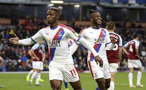 Crystal Palace's Wilfried Zaha celebrates scoring his side's third goal of the game with teammate Michy Batshuayi, during the English Premier League soccer match between Burnley and Crystal Palace, at Turf Moor, in Burnley, England, Saturday, March 2, 201