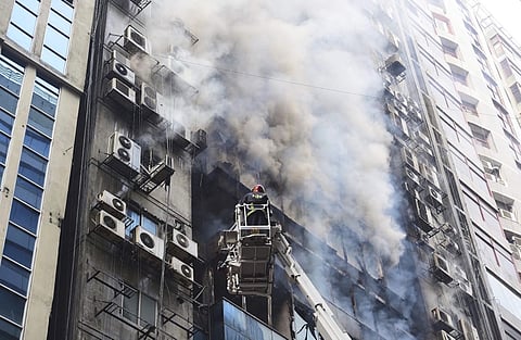 A firefighter works to douse a fire in a multi-storied office building in Dhaka, Bangladesh, Thursday, March 28, 2019. (Photo | AP)