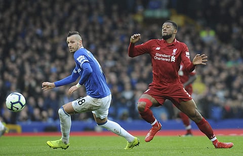 Liverpool's Georginio Wijnaldum, right, challenges for the ball with Everton's Morgan Schneiderlin. (Photo | AP)