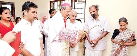 Verapoly Archbishop Joseph Kalathiparambil conducting the blessing ceremony of a house Express