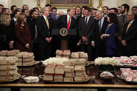 President Donald Trump welcomes the 2018 NCAA FCS College Football Champions, The North Dakota State Bison, to the State Dining room of the White House in Washington, Monday, March 4, 2019, with McDonald's and Chick-fil-A fast food. (Photo | AP)