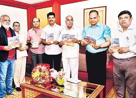 Chief Secretary SK Joshi and other officials display the copies of two books, ‘Telangana Rashtram - Vidhyut Vijayam’ and the ‘Saga of success - Telangana power sector’ during a ceremony on Monday | Express