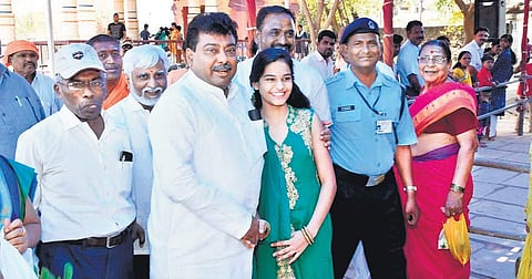 The girl posing with M B Patil outside the 770 Amaraganadishara temple