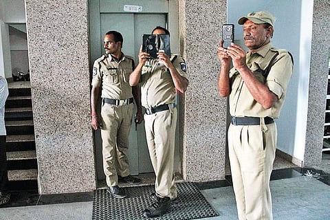 Cyberabad Police stand guard outside IT Grids India Private Limited’s office at Ayyappa Society, Madhapur in the city on Tuesday | S Sengabapandiyan