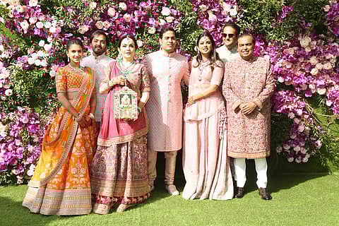From right: Mukesh Ambani, Anand Piramal with wife Isha, Akash, Nita and Anant Ambani, and Radhika Merchant at the wedding. (Photo: Twitter)