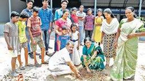 Ayyappan and Tripunithura Municipal chairperson Chandrika Devi planting a sapling at Govt Boys High School