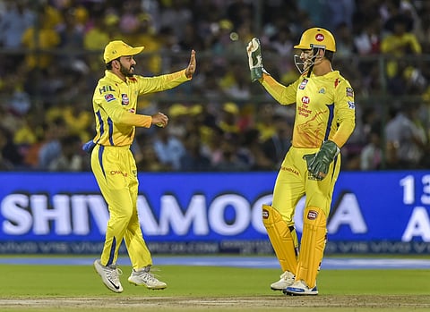 MS Dhoni celebrates a wicket with Kedar Jadhav. (Photo | PTI)