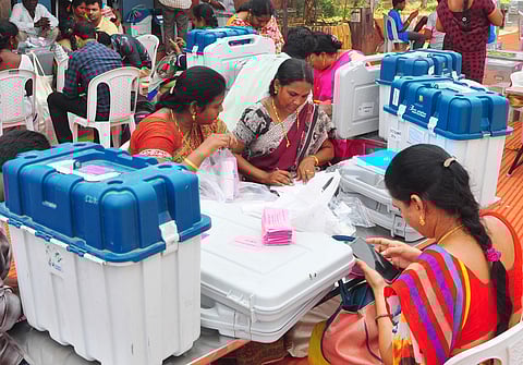 Election staff checking the EVMs and voters' list before transporting them to the polling stations at AU Engineering Grounds in Visakhapatnam on Wednesday. (Photo | G Satyanarayanan, EPS)