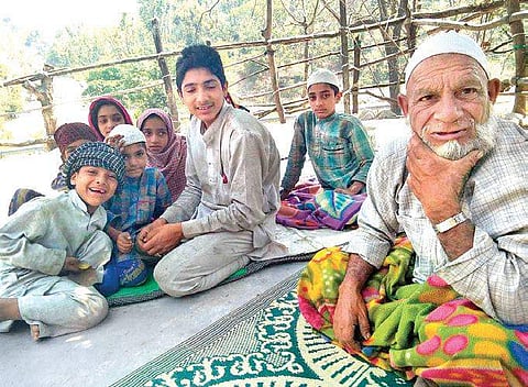 Van Gujjar Mohd Jumman with his grandchildren. | Express Photo Services