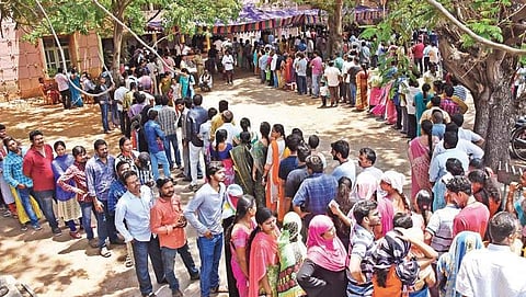 People stand in serpentine queues to cast their votes at a polling booth in Auto Nagar, Vijayawada on Thursday | RVK Rao