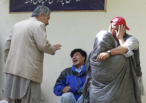 Family members of the blast victims comfort each other outside a mortuary in Quetta, Pakistan. (Photo | AP)