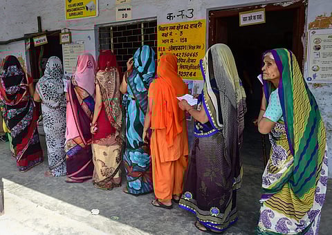 Women wait in queue to cast their votes at a polling stationat Bisahada near Noida (Photo | PTI)
