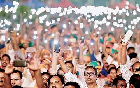 BJP workers turn on the flash lights on their mobile phones to welcome Prime Minister Narendra Modi at the Vijay Sankalp rally on Kozhikode beach on Friday | TP Sooraj