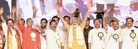 Prime Minister Narendra Modi waving at party workers during the Vijay Sankalp rally on Kozhikode beach on Friday | TP Sooraj