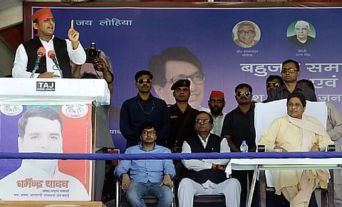 Samajwadi Party President Akhilesh Yadav addresses as Bahujan Samaj Party supremo Mayawati is seen on the stage during their joint election campaign rally in Badaun. (Photo | PTI)