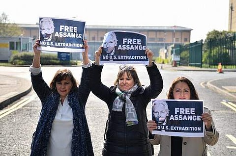 German Die Linke MPs Heike Hansel (C) and Sevim Dagdelen (R) and Spanish MEP Ana Miranda Paz (L) pose with placards calling for freedom for WikiLeaks founder Julian Assange (Photo|AFP)