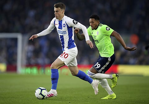Brighton's Jamie Paterson, left, and Cardiff City's Nathaniel Mendez-Laing battle for the ball during the English Premier League soccer match. (Photo | AP)
