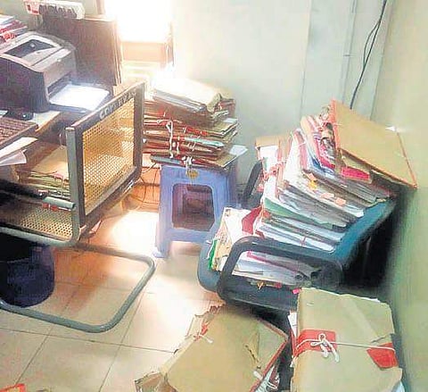 A large number of files and folders have been kept on chairs and even the floor at Rangareddy collectorate in the city | Express