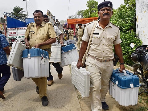 Security officials collect Electronic Voting Machines EVM and other election material from a distribution centre for the second phase of the 2019 Lok Sabha elections in Bhagalpur Wednesday April 17 2019. (Photo | PTI)