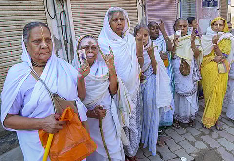 Elderly widows show inked fingers after casting their vote in Mathura. (Photo | PTI)