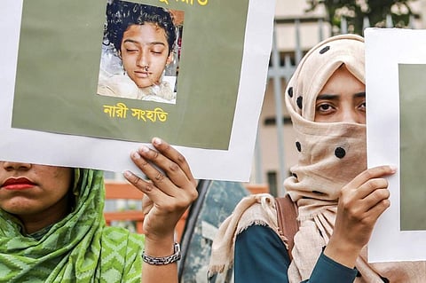 Bangladeshi women hold placards and photographs of schoolgirl Nusrat Jahan Rafi at a protest in Dhaka, following her murder by being set on fire after she had reported a sexual assault. (Photo | AFP)