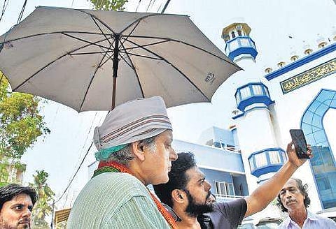 UDF candidate Shashi Tharoor posing for a selfie with a man outside a mosque B P Deepu