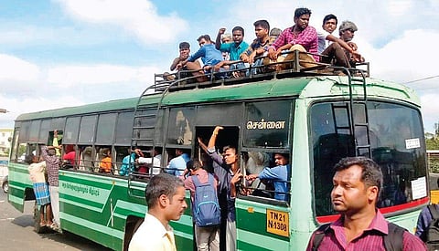 People travel on rooftop of a bus at Perungalathur in the city to reach their native places to cast votes | Express