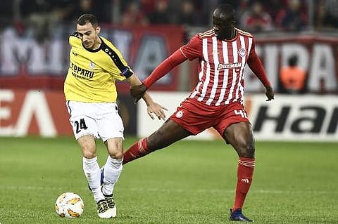 Olympiakos' Ivorian midfielder Yaya Toure (R) vies for the ball with F91 Dudelange's German midfielder Edisson Jordanov during the UEFA Europa League. (Photo | AFP)