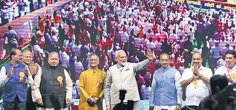 Prime Minister Narendra Modi waves to the crowd at the BJP’s trader convention at Talkatora Stadium on Friday. Union Minister Vijay Goel (blue waistcoat) accompanied Modi | Shekhar Yadav
