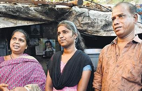Durga with her parents at her home in Periyamedu on Friday | D SAMPATHKUMAR
