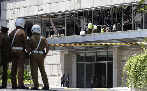 Police and forensic officials inspect a blast spot at the Shangri-la hotel in Colombo, Sri Lanka, on Sunday. (Photo | AP)