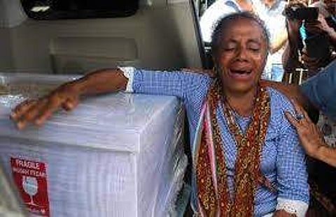 In this file photo taken on February 17, 2018, Petronela Koa cries next to the coffin containing her niece Adelina Sau, a domestic helper who died in Malaysia. (Photo | AFP)