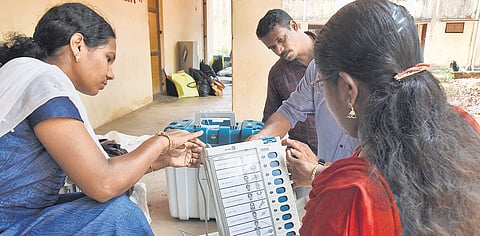 Officers checking the voting machines before transporting them to their respective booths from Swathi Thirunal Music College on Monday | B P Deepu