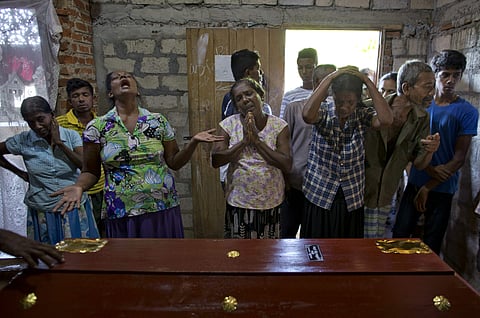 Relatives weep near the coffin with the remains of 12-year Sneha Savindi, who was a victim of Easter Sunday bombing at St. Sebastian Church, 22 April, 2019 in Negombo, Sri Lanka. (Photo | AP)