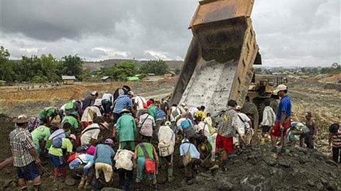 Freelance jade miners collect jade stones in an earth dump of a companies' mining field in Kachin State, Northern Myanmar. (Photo | File/ AP)