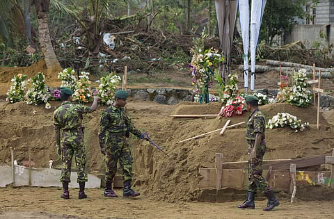 Officers of Special Task Force search for explosives ahead of mass burials at a burial ground in Sri Lanka (Photo| AP)