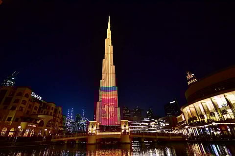 A picture taken on April 25, 2019 shows the Gulf emirate's Burj Khalifa, the world's tallest skyscraper, lit with an image of Sri Lanka's national flag in solidarity with the country following the April 21 'terrorist' attacks against hotels and churches c