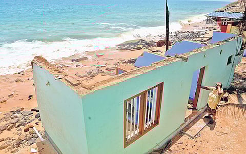 Mariyamma Manuel, from Valiyathura in Thiruvananthapuram, is desolate on finding that her house is damaged heavily by rough waves on Thursday | Vincent Pulickal