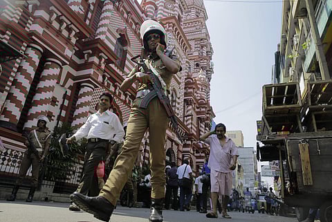 A Sri Lankan police officer patrols out side a mosque in Colombo. (Photo|AP)