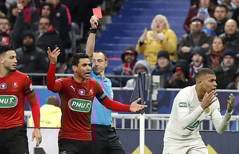 PSG's Kylian Mbappe, right, reacts after receiving a red card during the French Cup soccer final against Rennes (Photo | AP)