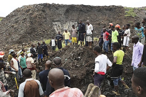 Locals and rescuers gather around a site where two houses were crushed by the collapse of a massive, sprawling dumpsite that hit just after midnight when rains poured in Pemba city on the northeastern coast of Mozambique, Monday, April, 29, 2019. (Photo |