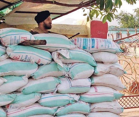 A BSF jawan guarding the main gate of Government Girl’s High School building where EVMs and VVPAT machines have been stored | Express