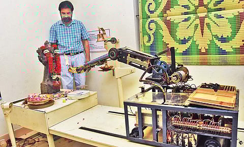 V S Sabu watches as the robot performs puja at his lab near Thiruvallam in Thiruvananthapuram | B P Deepu