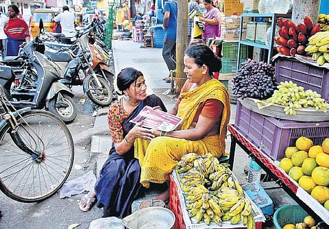 M Radha interacting with a fruit seller at Mylapore in Chennai on Tuesday | DEBADATTA MALLICK