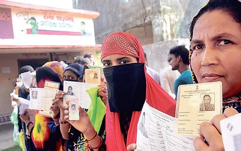 Muslim women voters showing their identity cards before casting votes at a polling station in Kendrapara district on Monday | Biswanath Swain