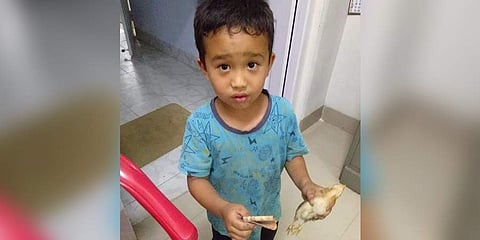 The photo of Derek C Lalchhanhima and the chicken that has gone viral on social media