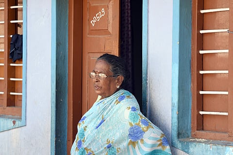64-year-old Indrani standing infront of her sheet house at Lakshmanpuri slum in Gandhinagar where BS Yeddyurappa stayed last year during Assembly election. (Express photo|NAGARAJA GADEKAL)
